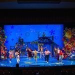 Photo: A wide shot of the stage during the Wheelock Family Theatre's production of "The Spongebob Musical." The set features lots of blues, to simulate being underwater, and the actors are in colorful attire. Along the side of the stage is colorful stacks of memorabilia